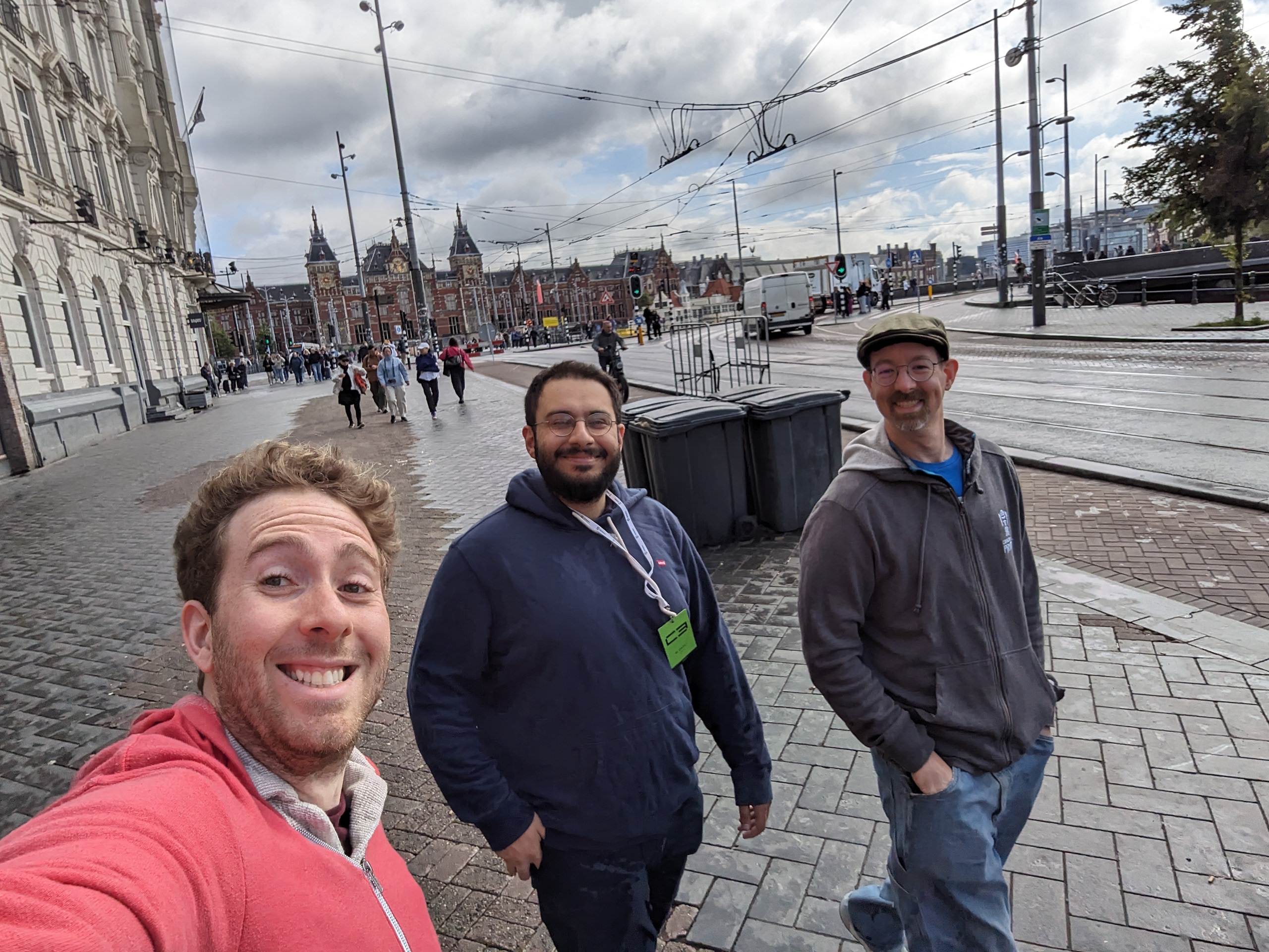 Selfie of me walking with two smiling guys on the streets of Amsterdam.